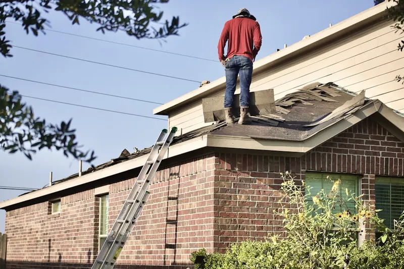 Professional roofer working on a residential roof in Pioneer